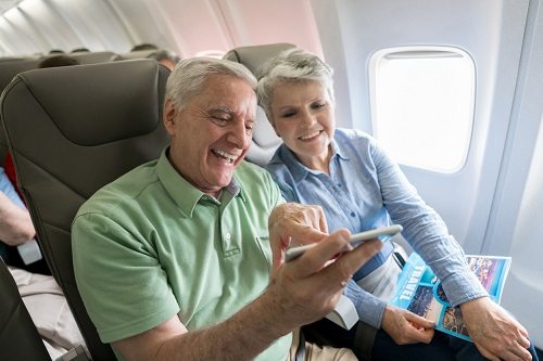 Personas mayores, viajando en un avión
